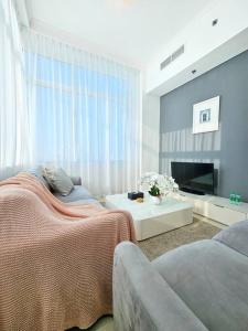 uma sala de estar com uma cama e um sofá em Luxury Botanica Apartment 67 em Dubai