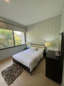 سرير أو أسرّة في غرفة في Abdoun Falls Luxury Apartment