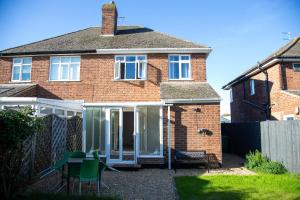 a brick house with a sliding glass door at Fully renovated spacious home, Sleeps 5, in Grantham