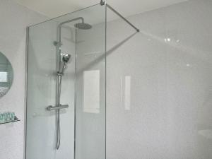 a shower with a glass door in a bathroom at Pass the Keys Quiet Hidden Gem in Swansea CitySleeps 5 in Swansea