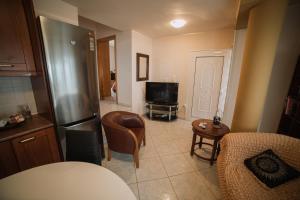 a kitchen with a refrigerator and a tv in it at Niki House in Volos