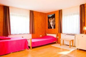 a room with two beds and two windows at Apartment House Anton with free parking in Bovec