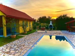 a swimming pool in the yard of a house at Abacus House in Csopak