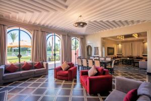 a living room with couches and a dining room at Janat Al Atlas Resort & Spa in Marrakesh