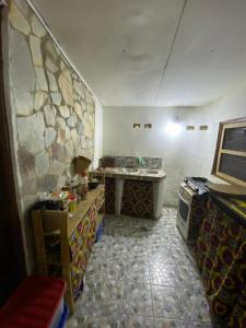a kitchen with a table and a stone wall at Lodge au paradis fleuri 