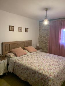 een slaapkamer met een bed met 2 kussens erop bij La Casa Rural de Pálmaces in Pálmaces de Jadraque