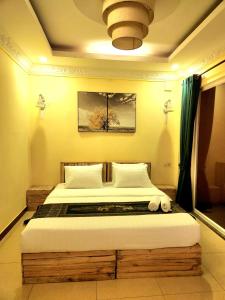 a bedroom with a large bed in a room at SOMA HOTEL in Phnom Penh