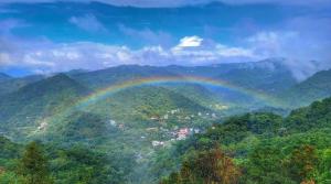 a rainbow in the middle of a mountain at 森活藝術文旅 in Shiding