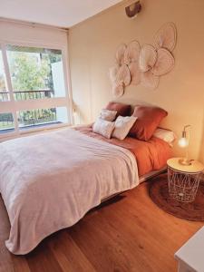 1 dormitorio con 1 cama grande con flores en la pared en Appartement neuf proche parc de Versailles + parking, en Le Chesnay