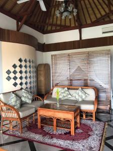 a living room with a couch and a coffee table at Alam Sweet Ulu-Modern "Balinese Style Villa" 3 Large Comfy Beds 2 private Bedrooms, Panoramic Ocean Views Pool in Uluwatu