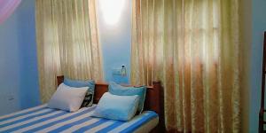 מיטה או מיטות בחדר ב-Pravindi Guest Home