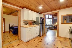 a kitchen with white cabinets and a stainless steel refrigerator at Weston Vacation Rental - Close to Ski Resorts! in Weston