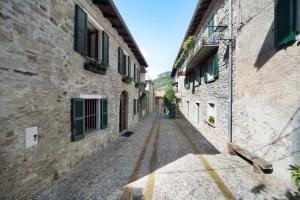 an alley in an old town with stone buildings at Casa Almut & More - Lake Como Center - Varenna in Perledo