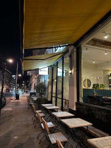 a row of tables outside of a restaurant at night at Room in Central London Overview Thames in London
