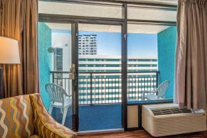 a room with a balcony with a view of a city at Renovated Condo at Landmark Resort, Waterpark View in Myrtle Beach
