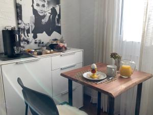 a small kitchen with a table with a plate of food on it at B&B Biel-Brügg in Brügg