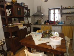 a kitchen with a table with a cake on it at La Chicca in Carrara