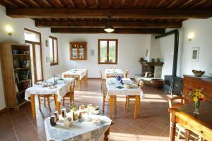 a room with tables and chairs in a room at Agriturismo PEDROSOLA in Brisighella