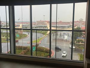 a view of a city from a window at PRESIDENCY AIRPORT HOTEL in Cochin