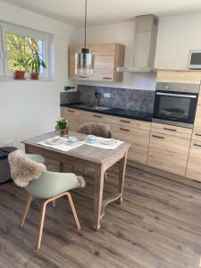 a kitchen with a wooden table and a chair at Hygge Haltern in Haltern
