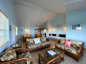a living room with couches and a dining room at Hideaways Exuma in Georgetown