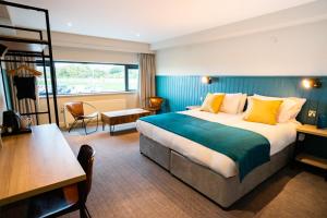 a hotel room with a bed and a desk at The Lake House in Liverpool