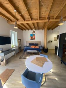 a bedroom with a bed and a table and chairs at A LA BELLE ETOILE in Montbrison