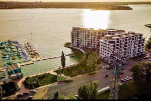 a large building next to a large body of water at Apartament Resort in Constanţa