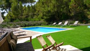 a group of chairs and a swimming pool at Masia Sapera in Pontons