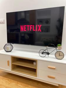 a flat screen tv on a white entertainment center at Las Terrazas de Vigo in Vigo