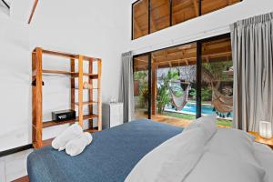 מיטה או מיטות בחדר ב-Villa Ave del Paraíso
