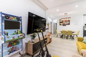 a living room with a tv and a video game at LUJO: Parking, Proyector, Maquinita y Patinetes in Oviedo