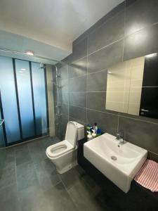 a bathroom with a white sink and a toilet at GS home in Nusajaya