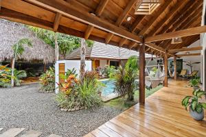 un patio al aire libre con piscina y una casa en Villa Ave del Paraíso, en Playa Avellana