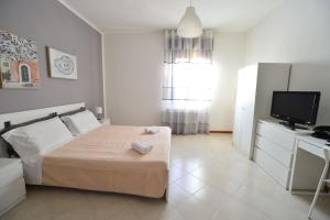a bedroom with a bed and a television in it at Casa Laita in Sarego