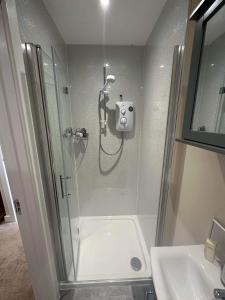a bathroom with a shower and a sink at The Barn in South Witham