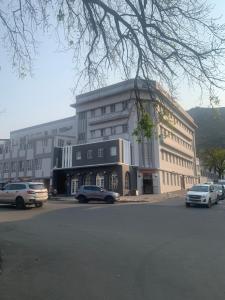 a large building with cars parked in front of it at Peper Korrel in Paarl