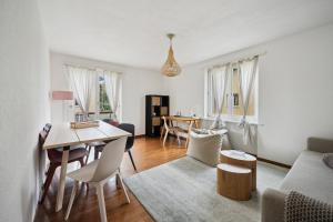 a living room with a table and a dining room at Altwiesenstrasse 144 in Zürich