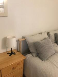 a bedroom with a bed with a lamp on a night stand at Domaine La Bonne Dame I, au coeur des Vosges in Plainfaing