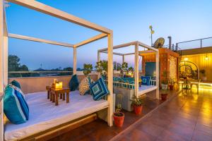 a porch with two beds on a balcony at Blue Door in Būndi
