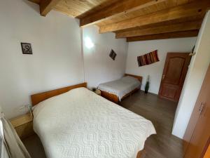a bedroom with two beds in a room with wooden ceilings at Villa Forrest Bușteni in Buşteni
