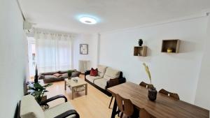 a living room with a table and a couch at Apartamento ZONA in Albacete