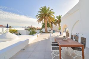 a patio with a wooden table and chairs at Mauresque Experience Luxury in Torremolinos