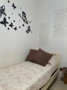 a bedroom with a bed with butterflies on the wall at La Villetta in Rende