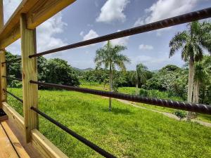 a view of a field from the porch of a house at Tierra Adentro Bed and Breakfast in Naguabo