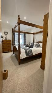 een slaapkamer met een houten bed in een kamer bij Quarry Cottage near Hawes, Yorkshire Dales, Pet free in Hawes