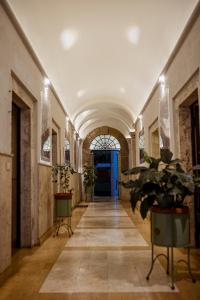 a hallway with a tile floor and a blue door at Al Catillo in Tivoli