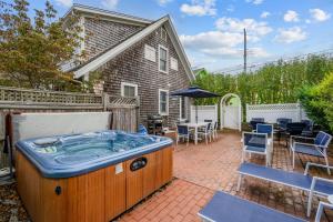a hot tub in the backyard of a house at Walk to Beach and Town, Hot tub, Sleeps 8, Pet Friendly in Chatham