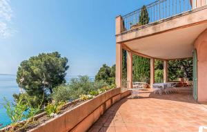 a balcony of a house with a view of the ocean at Villa la Malpagne, 400m2 les pieds dans l'eau in Rayol-Canadel-sur-Mer