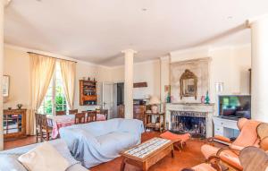 a living room filled with furniture and a fireplace at Villa la Malpagne, 400m2 les pieds dans l'eau in Rayol-Canadel-sur-Mer